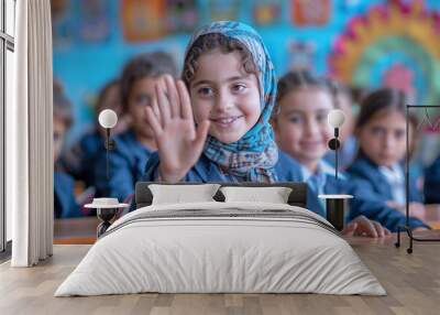 Arab school girl raised hand to answer a teacher's question in a classroom Wall mural