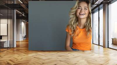 Blonde woman wear orange casual t-shirt smile isolated Wall mural