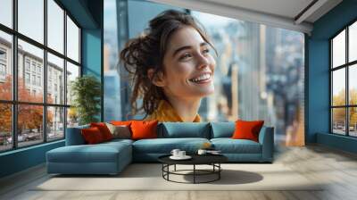 Brunette business woman happy in modern office looking at the future Wall mural