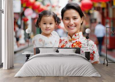 Hispanic mother and daughter in cheongsam enjoy the lunar new year celebration Wall mural