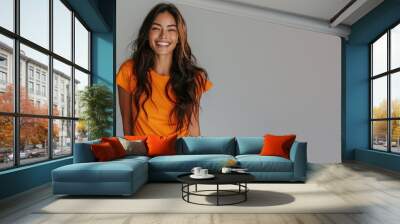 Hispanic woman wear orange casual t-shirt smile isolated Wall mural