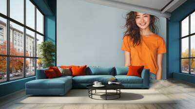 Japanese woman wear orange casual t-shirt smile isolated Wall mural