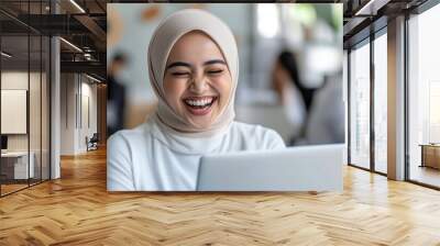 Malay business woman happy working using laptop at office workplace Wall mural