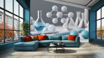 Creative scientific workspace featuring laboratory glassware, molecular model, and blue liquids on a clean desk. Wall mural