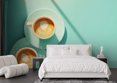 Two cups of coffee with latte art on a blue background with light shining through the window. Wall mural