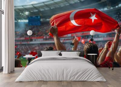 Turkish football soccer fans in a stadium supporting the national team wearing red shirt, supporting , cheering and rising Turkish national flag in european football league Wall mural