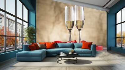 two champagne glasses with red ribbon on wood board.valentines d Wall mural