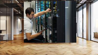 it technician with network equipment and tablet Wall mural