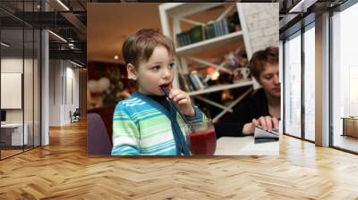 Boy tasting smoothies Wall mural