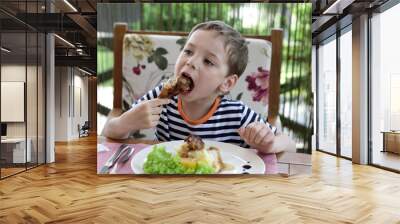 Child eating chicken leg Wall mural