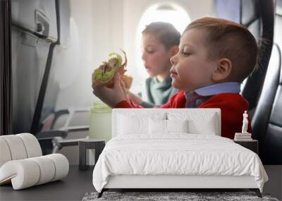 Children eat on the plane Wall mural