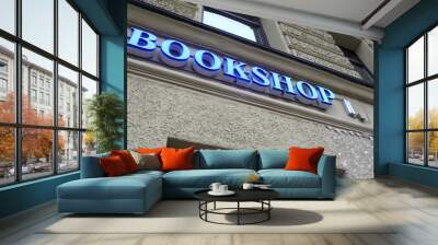 Glowing bookshop sign board on wall Wall mural