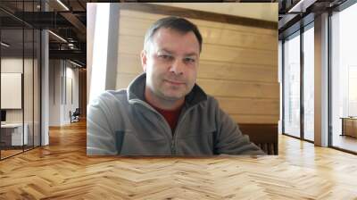 Man posing in restaurant Wall mural