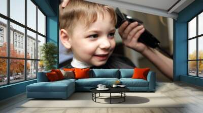 Smiling child at the barbershop Wall mural