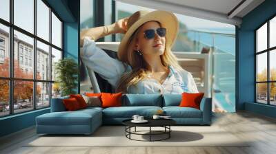 Beautiful young woman smiling relaxing in chair on balcony, vacation concept Wall mural