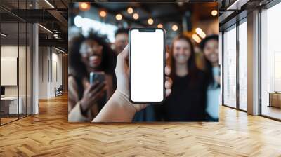 Hand holding showing an isolated smartphone device with blank empty white screen with happiness smiling laughing young people friends, social communication technology concept Wall mural