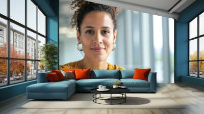 Headshot portrait of a brunette woman smiling in creative office environment Wall mural