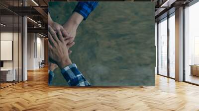 Engineers work together to accept cooperation, agree on the concept of success Close up of business people hand in hand in solidarity. Wall mural