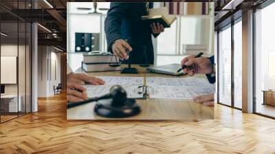 Lawyer working with client discussing contract documents with legal brass in consulting office to help client, close-up photo Wall mural