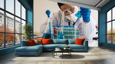 science laboratory test tube A device for young healthcare researchers working in life science laboratories. A young man research scientist prepares and analyzes with a microscope Wall mural