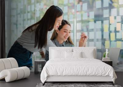 Two Asian businesswomen discussed their ideas at a meeting.
Two people discuss working on investment projects and planning strategies. Businessman talking with laptop computer at office Wall mural