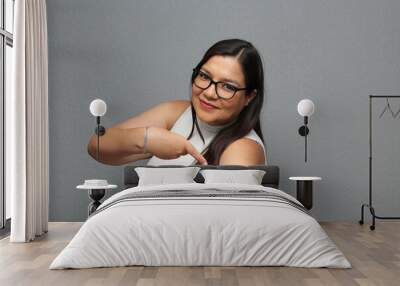 Happy Latina adult woman shows her arm that just received the Covid-19 vaccine in the new normal for the coronavirus pandemic
 Wall mural