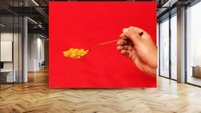 Traditional paella rice from Valencia Spain, made with saffron shellfish, shrimp and vegetables served on a wooden board and a hand taking a fork on a white background
 Wall mural