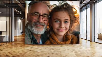 A heartwarming portrait of a grandfather with his granddaughter, evoking family ties and affection during the golden hour. Wall mural