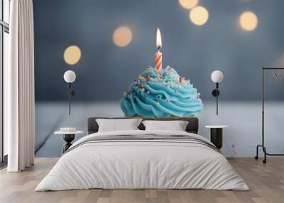 Birthday cupcake colourful and delicious, decorated with cream frosting and sprinkles illuminated by burning candle. Perfect for any happy celebration. Wall mural