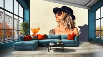 Beautiful girl in drinks Aperol Spritz wine from a glass in a restaurant, a cafe, has a good weekend, a stylish fashionable woman, a brunette young, emotional, outdoor close up hipster portrait Wall mural