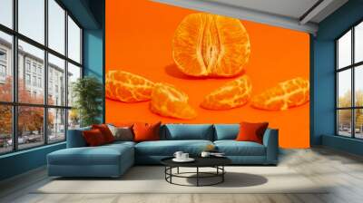 A peeled tangerine photographed in studio isolated in macro with an orange background Wall mural