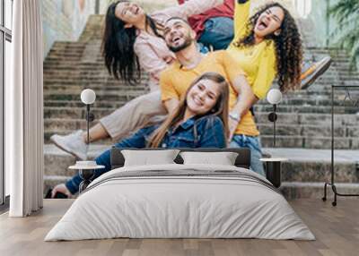 Group of happy friends having fun on the city streets - Multiracial young people laughing with arms raised - Friendship concept. Wall mural