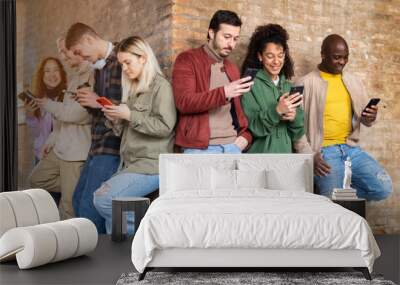 Group of multiracial friends using smartphones to sharing content on social networks. Technology lifestyle concept - Selective focus. Wall mural