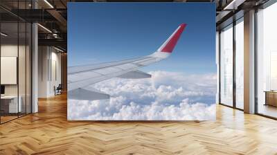 view of white clouds in the sky from the window of an airplane over the wing Wall mural