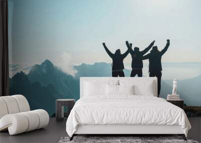 Together overcoming obstacles with three people holding hands up in the air on mountain top. We Made It. Celebrating success and achievements. Wall mural