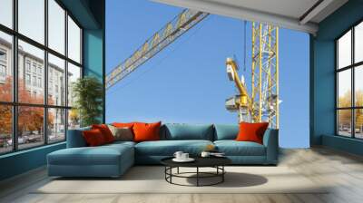 two yellow construction cranes isolated on blue sky Wall mural