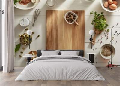 Overhead view of a kitchen counter with ingredients, utensils, and a cutting board, space at the top for logos Wall mural