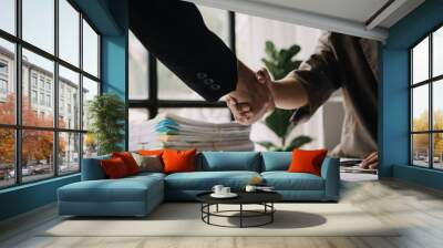 Business handshake for teamwork of business merger and acquisition,successful negotiate,hand shake,two businessman shake hand with partner to celebration partnership and business deal concept Wall mural