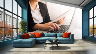 businesswoman hand using smart phone, tablet payments and holding credit card online shopping, omni channel, digital tablet docking keyboard computer at office in sun light with film grain effect Wall mural