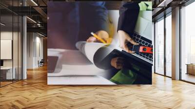 Construction engineer working at blueprint to build large commercial buildings in office. Engineering tools and construction concept. Wall mural