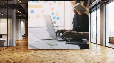 Financial analysts analyze business financial reports on a digital tablet planning investment project during a discussion at a meeting of corporate showing the results of their successful teamwork. Wall mural