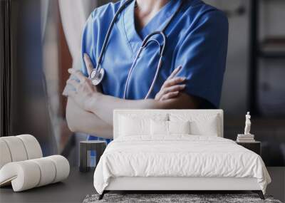 Homecare nursing service and elderly people cardiology healthcare. Close up of young hispanic female doctor nurse check mature caucasian man patient heartbeat using stethoscope during visit Wall mural