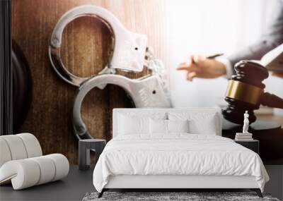 Justice and law concept.Male judge in a courtroom with the gavel, working with, computer and docking keyboard, eyeglasses, on table in morning light Wall mural