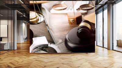 Justice and law concept.Male judge in a courtroom with the gavel, working with, computer and docking keyboard, eyeglasses, on table in morning light Wall mural