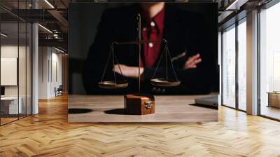 Justice and law concept.Male judge in a courtroom with the gavel, working with, computer and docking keyboard, eyeglasses, on table in morning light Wall mural