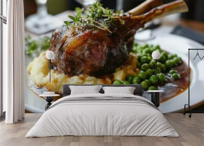 A delicious meal of roasted meat with mashed potatoes and peas, served with gravy on a white plate. Wall mural