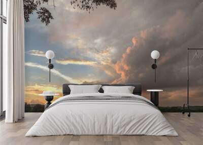 Countryside landscape showing dramatic sunset with lots of clouds and colors Wall mural