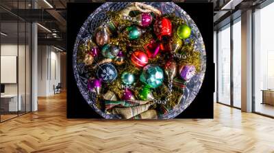 Closeup of holiday ornaments in a crystal bow on a black background. Wall mural