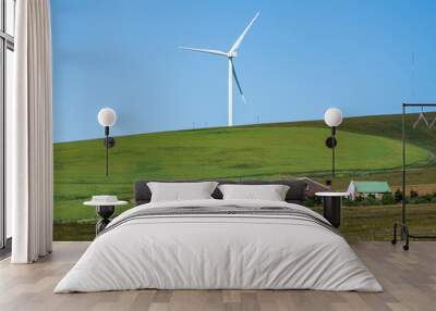 Close up shot of countryside house and a wind turbines with blue sky in the overberg Western Cape South Africa Wall mural