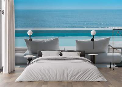 luxury swimming pool on sea view and beach chair in hotel resort Wall mural